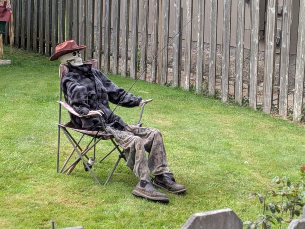 Picture of a skeleton fishing on a lawn, a great remote side hustle for stay at home dads.