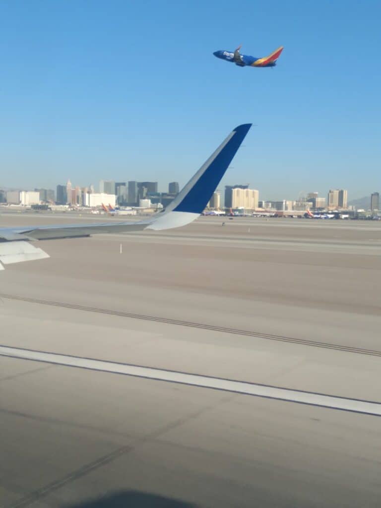 A plane on a a runway with Las Vegas, some wonder about the hidden costs of solo travel and how to avoid them.