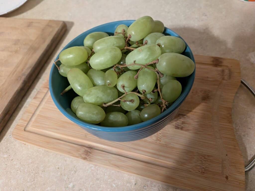A bowl of green grapes, some wonder about the top 3 travel insurance for food poisoning picks.