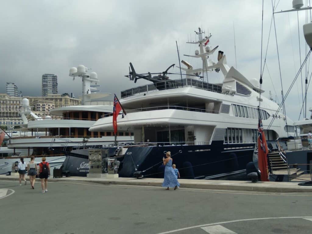 A picture of a luxury yacht with a helicoptor on it taken in Monte Carlo. Some wonder about high ticket affiliate marketing programs for small creators.